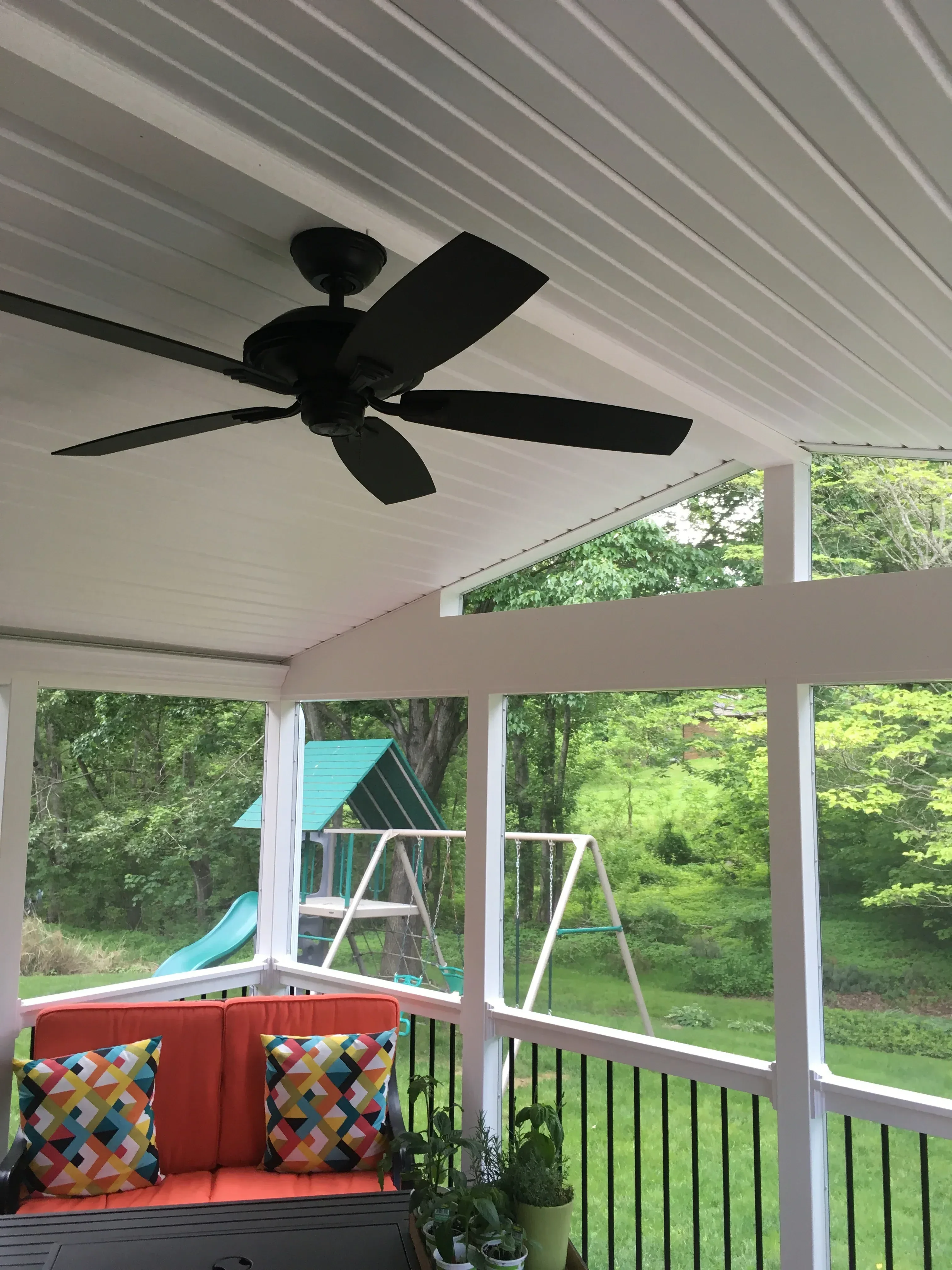 Standing seam metal roof patio with skylights and white metal frame structure