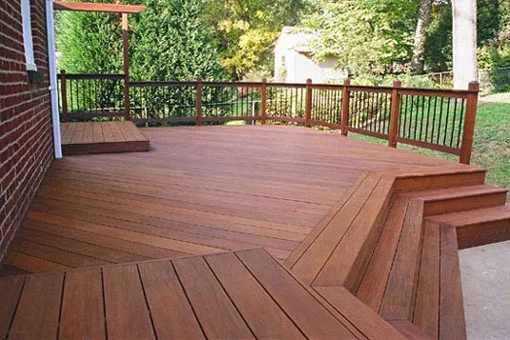Multi-level composite deck with stairs, diagonal and horizontal decking patterns, and composite railings