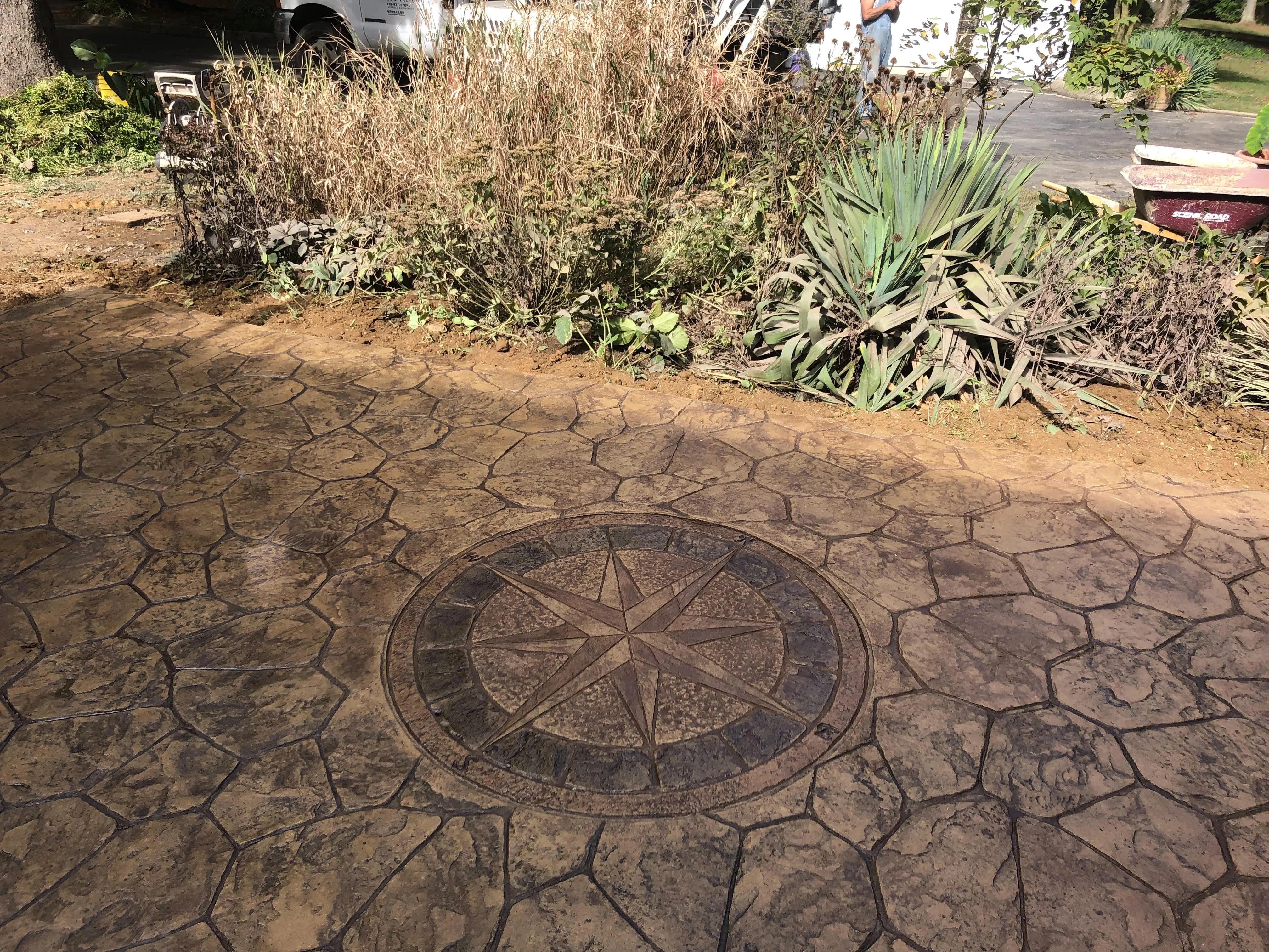 Stamped concrete patio with compass rose design and decorative border pattern